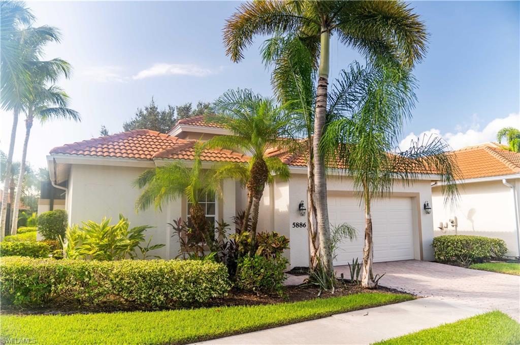 Mediterranean / spanish-style home with a garage