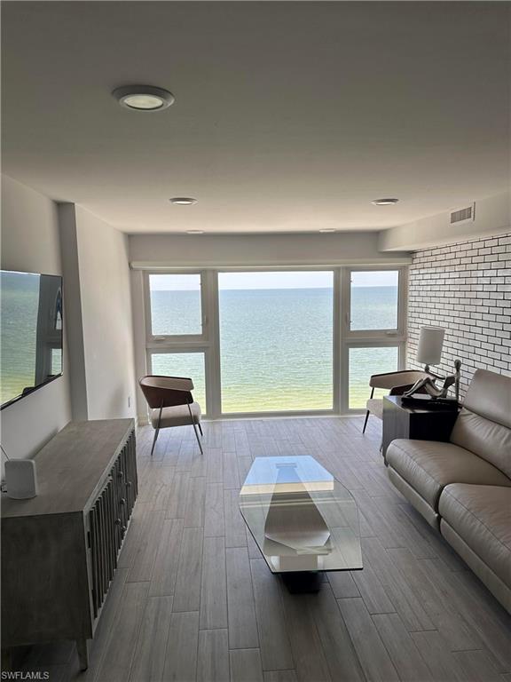 Living room featuring hardwood / wood-style floors and a water view