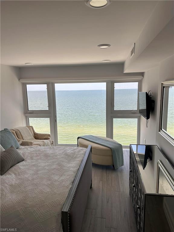 Bedroom with dark hardwood / wood-style flooring