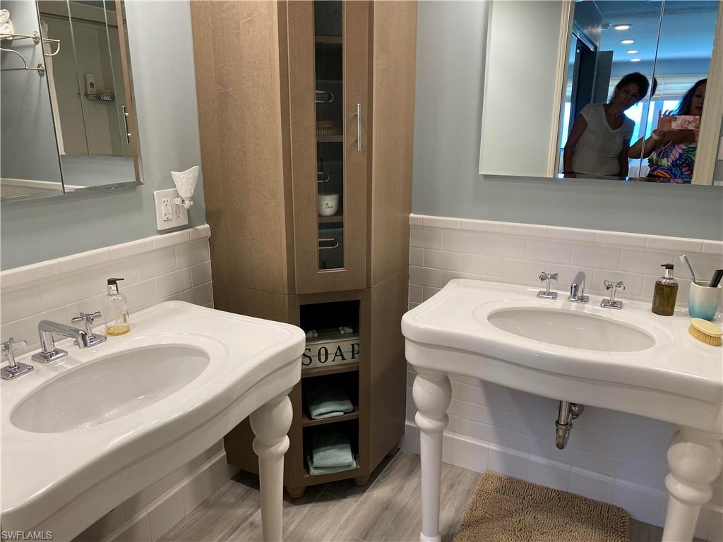 Bathroom featuring hardwood / wood-style flooring and decorative backsplash