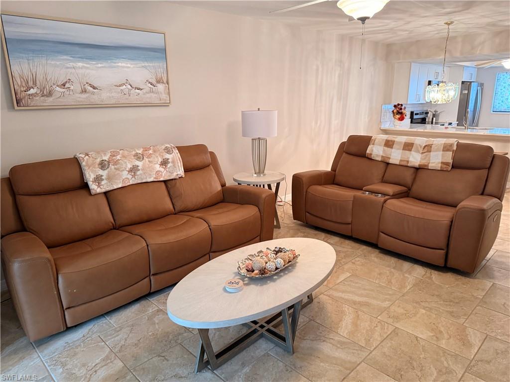 Open concept living area featuring neutral tone tile flooring and light wall finishes