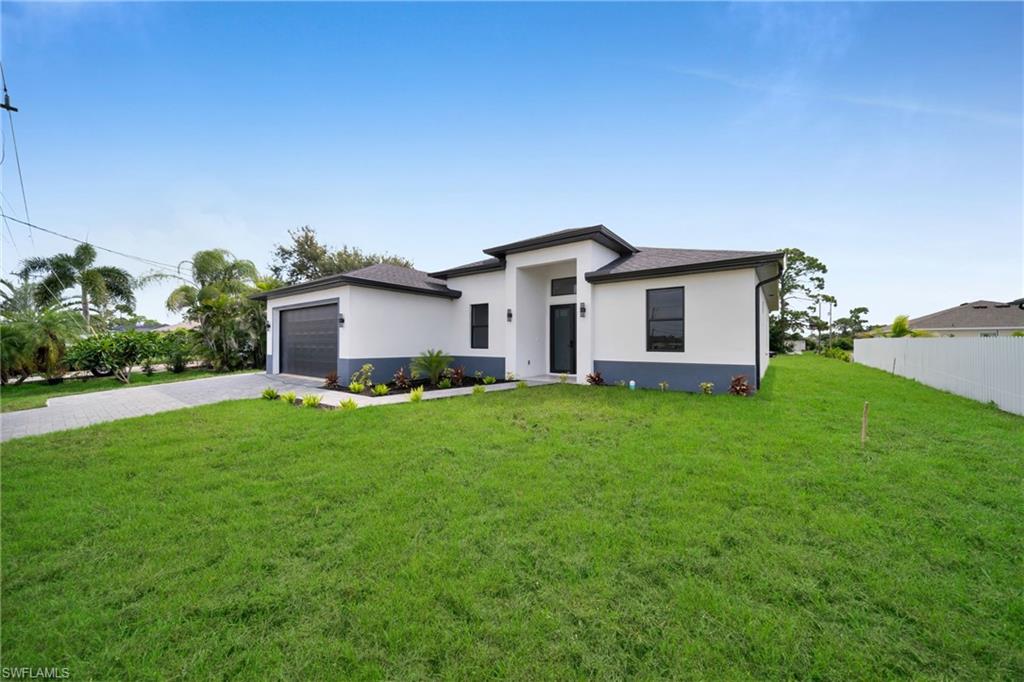 Contemporary single-story residence with a white stucco exterior and dark trim accents