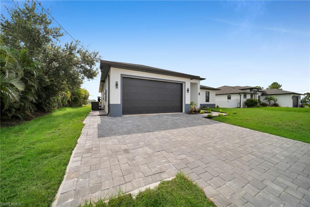 Contemporary exterior with a two-car garage and a modern dark panel door