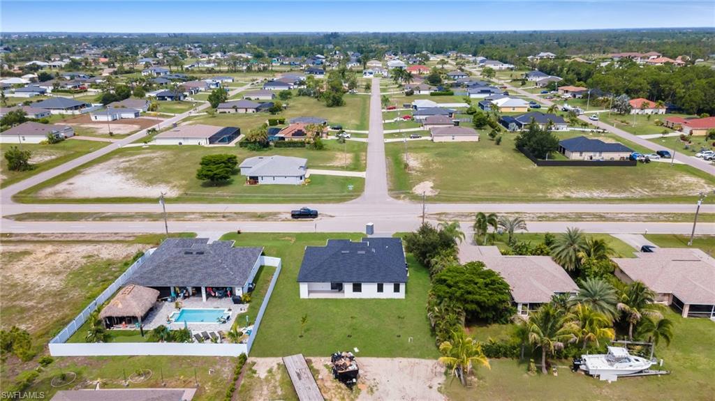 Aerial perspective of a neighborhood featuring single-story homes and undeveloped lots