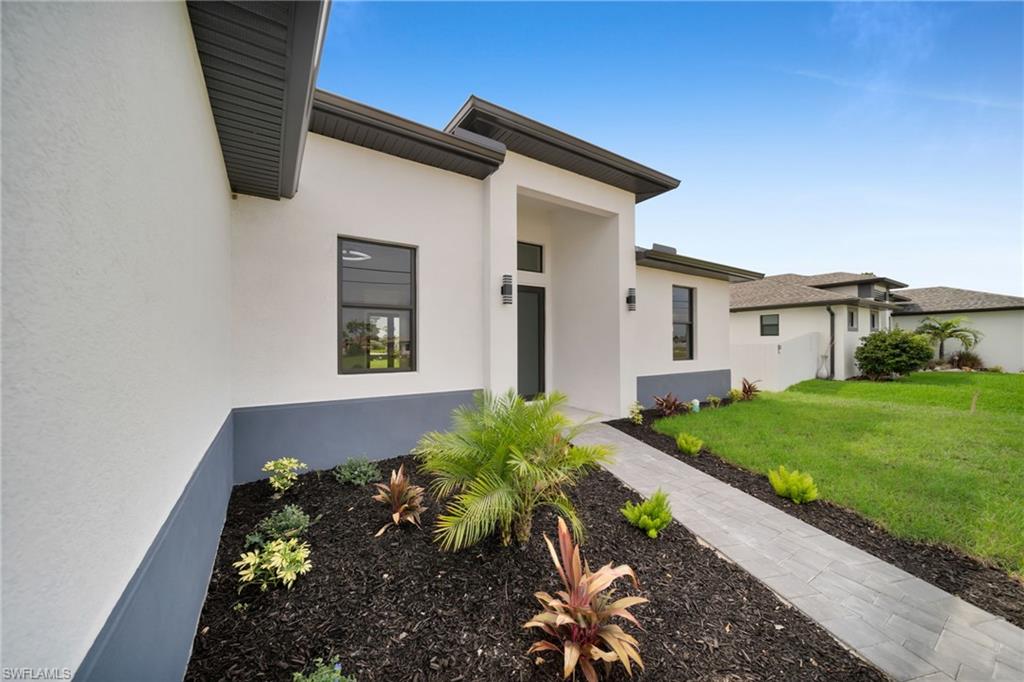Contemporary exterior with stucco finish and dark trim accents
