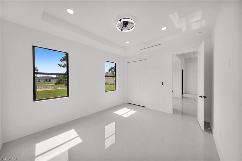 Bright interior space featuring two windows, recessed lighting, and a modern ceiling fan
