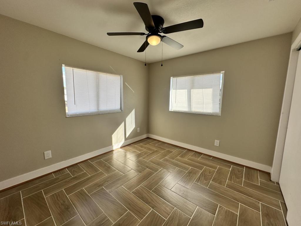 Unfurnished bedroom with a ceiling fan and parquet floors
