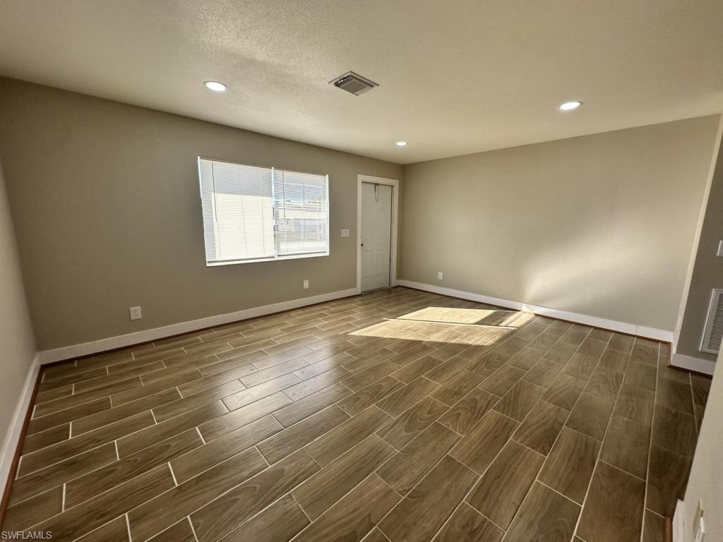 Unfurnished room with wood tiled floors and recessed lighting