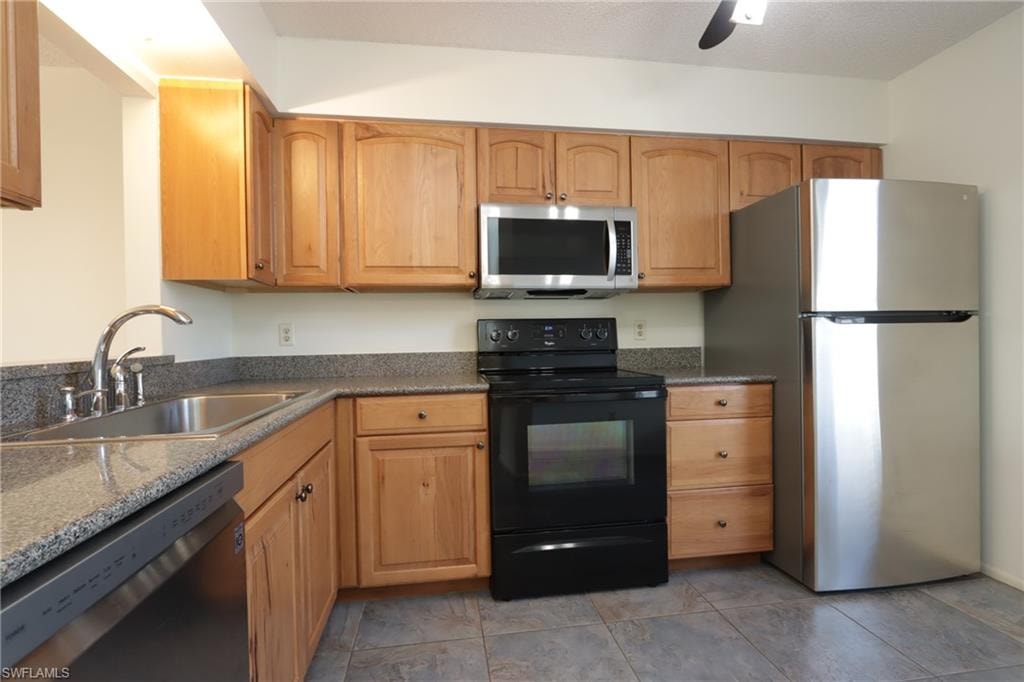 Kitchen featuring appliances with stainless steel finishes and a ceiling fan