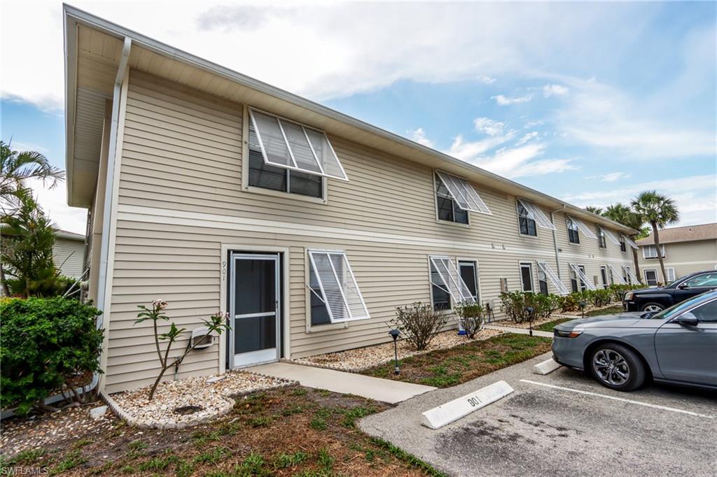 Rear view of property with uncovered parking