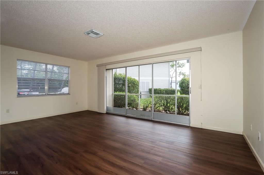 Spare room with a textured ceiling and dark wood finished floors