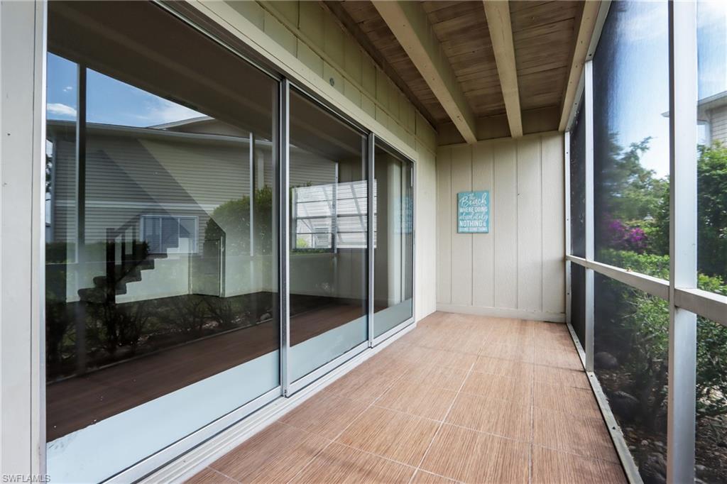 Unfurnished sunroom with healthy amount of natural light and beamed ceiling