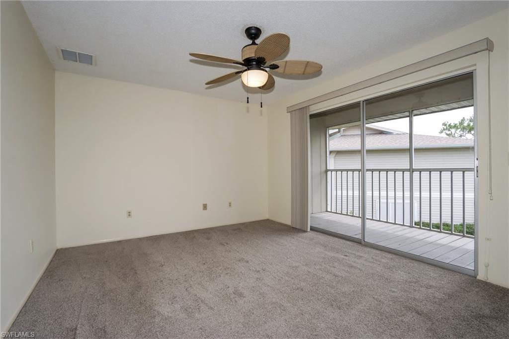 Carpeted empty room featuring ceiling fan and plenty of natural light
