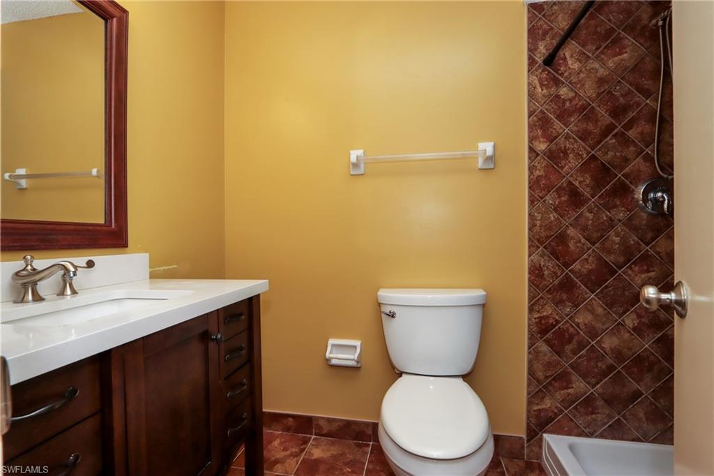 Full bath with vanity and tiled shower