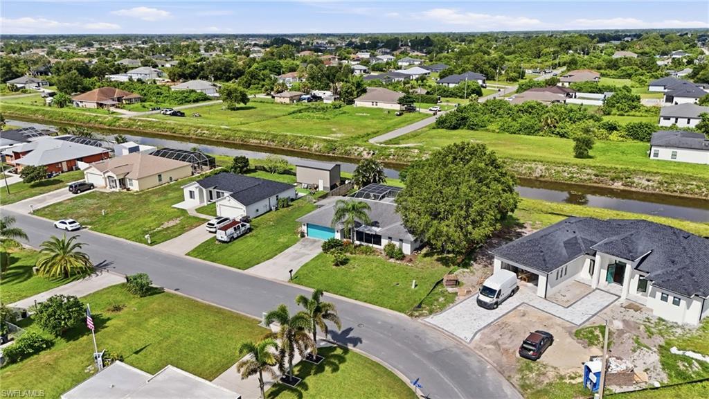 Aerial view of the area with canal behind the home