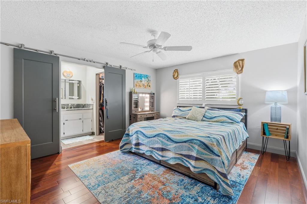 Primary bedroom with barn doors leading to the private bath
