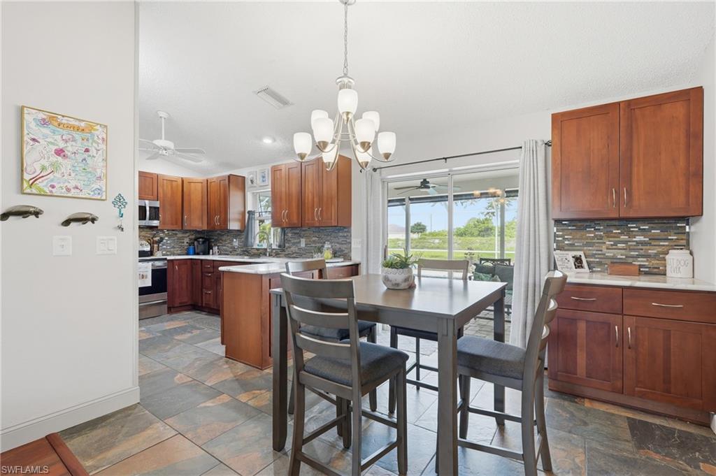 kitchen with coffee bar and sliding doors that lead out to the pool overlooking the canal