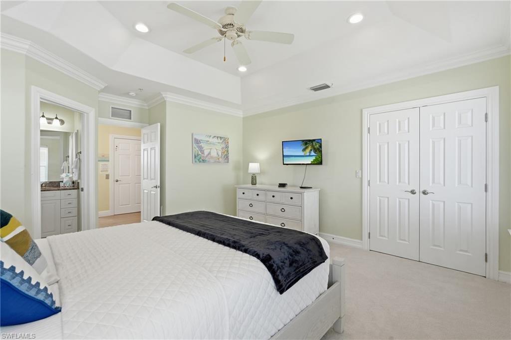Tray ceiling with crown molding, recessed lighting, ceiling fan, and carpeted flooring - Virtually Edited Image