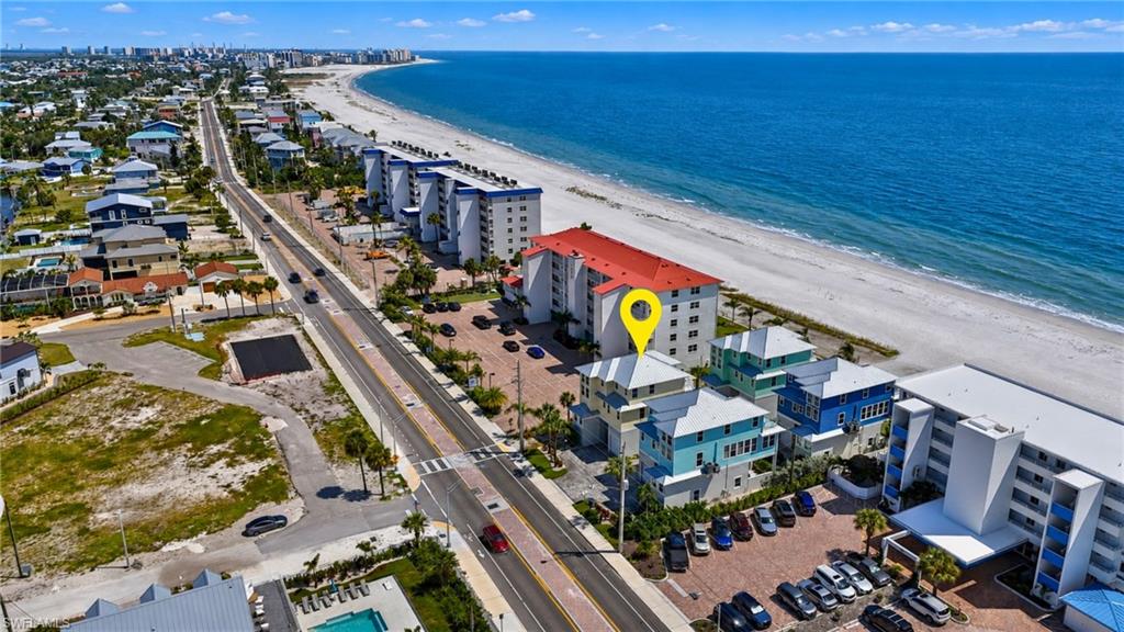 Coastal property with direct beach access, multi-story structure, and multiple balconies - Virtually Edited Image