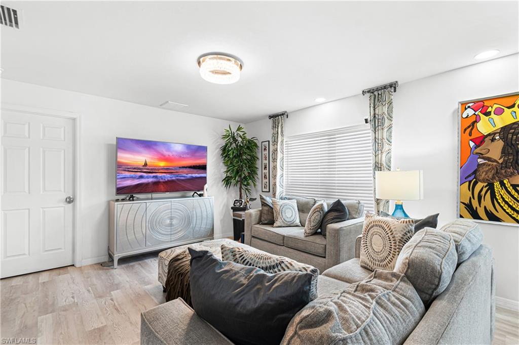 Living area featuring light wood-finish flooring and a neutral color palette