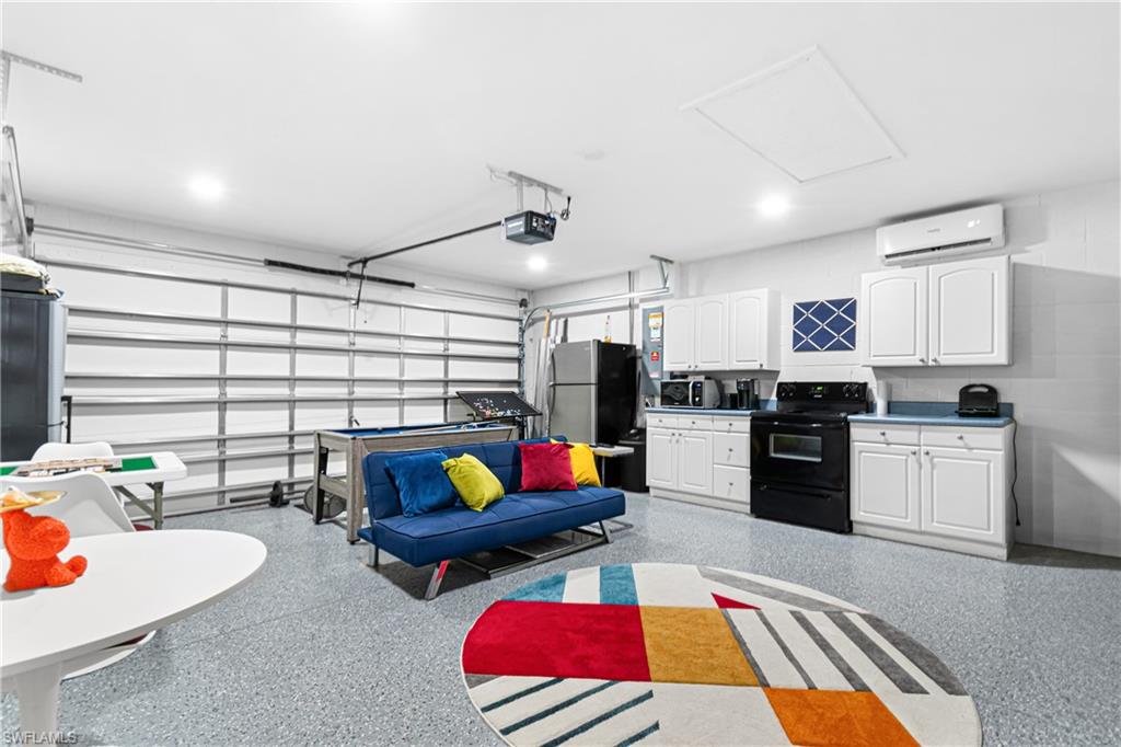 Spacious garage featuring a durable epoxy flooring and white paneled walls