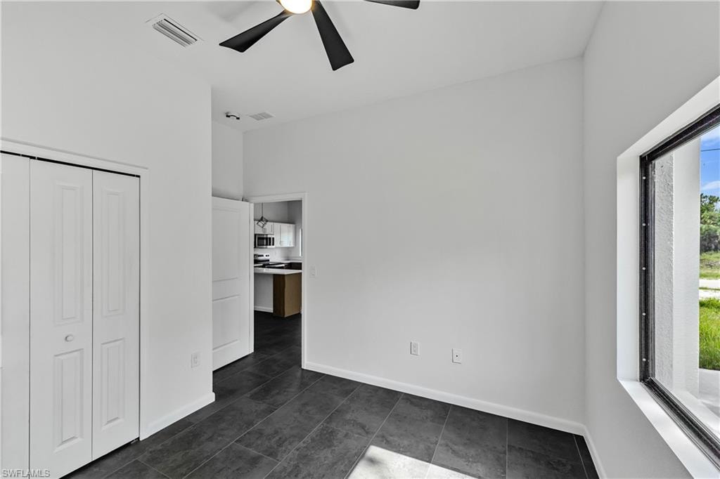 Interior space featuring dark tile flooring and a large window