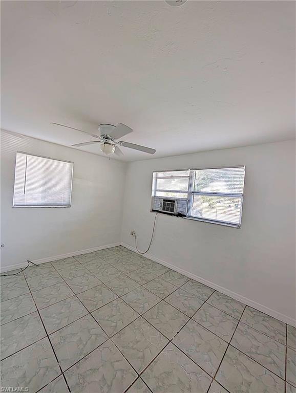 Interior room featuring light-colored square tile flooring and white walls