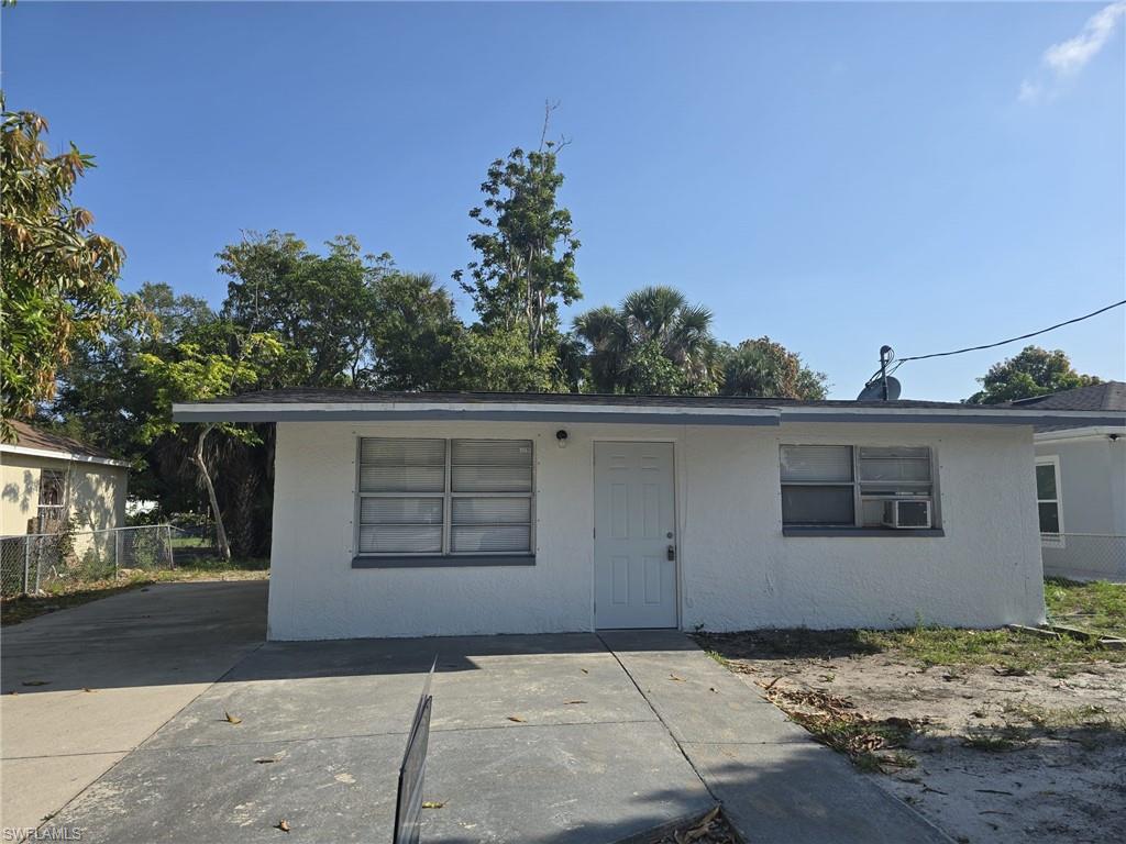 White stucco exterior with a flat roofline