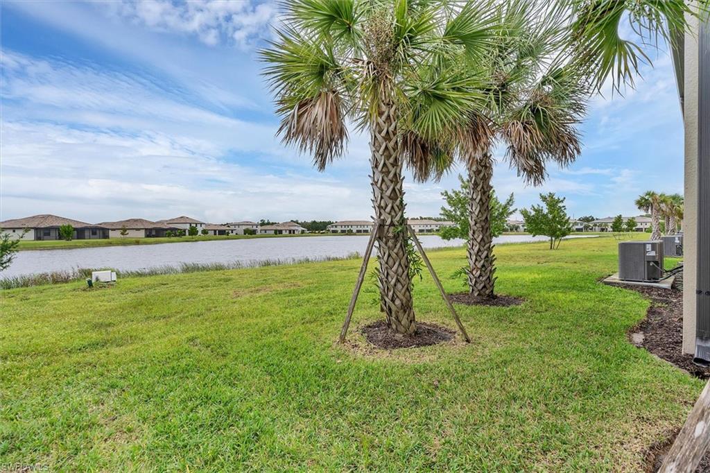 View of grassy yard featuring a water view and a residential view