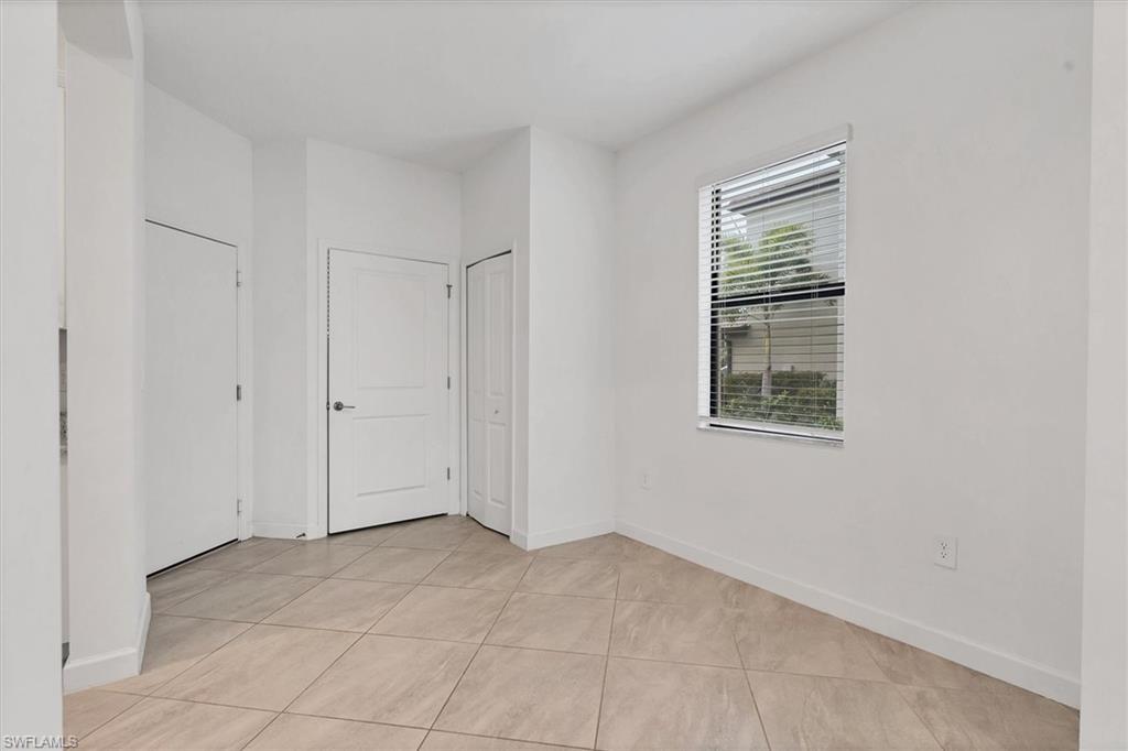 Unfurnished room with baseboards and light tile patterned floors