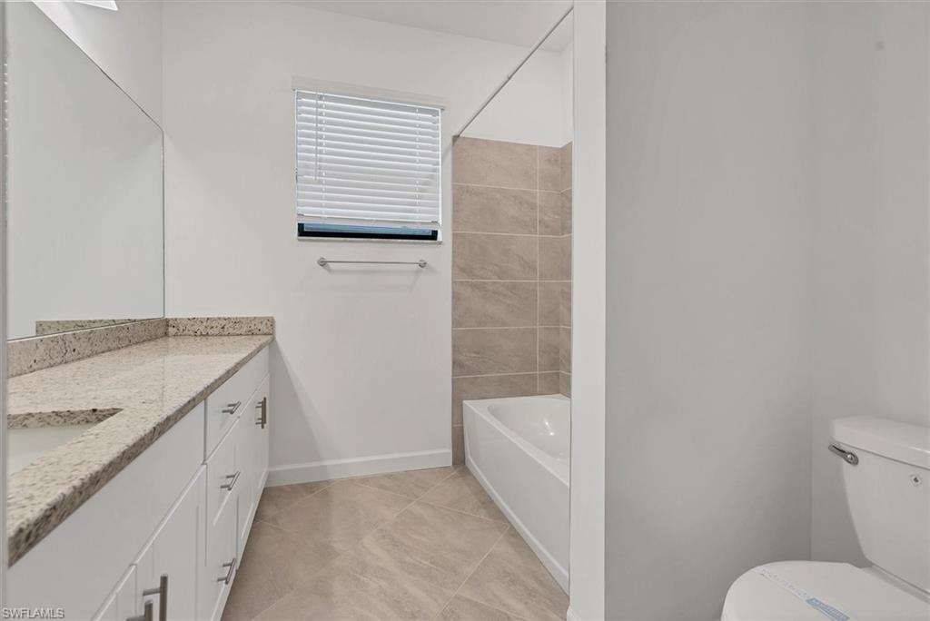 Full bath featuring vanity and bathing tub / shower combination