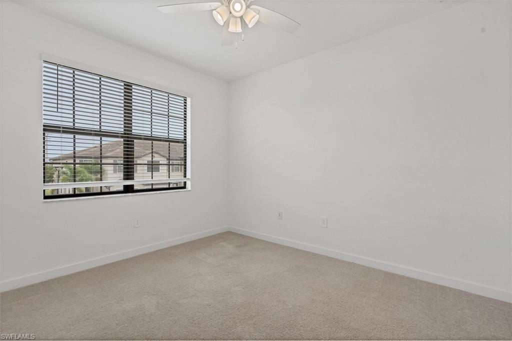 Unfurnished room with light carpet and a ceiling fan