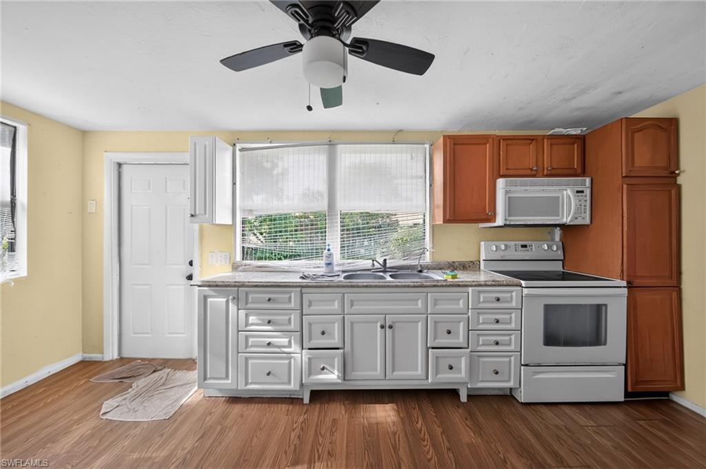Kitchen featuring wood-finish flooring and a ceiling fan with light fixture