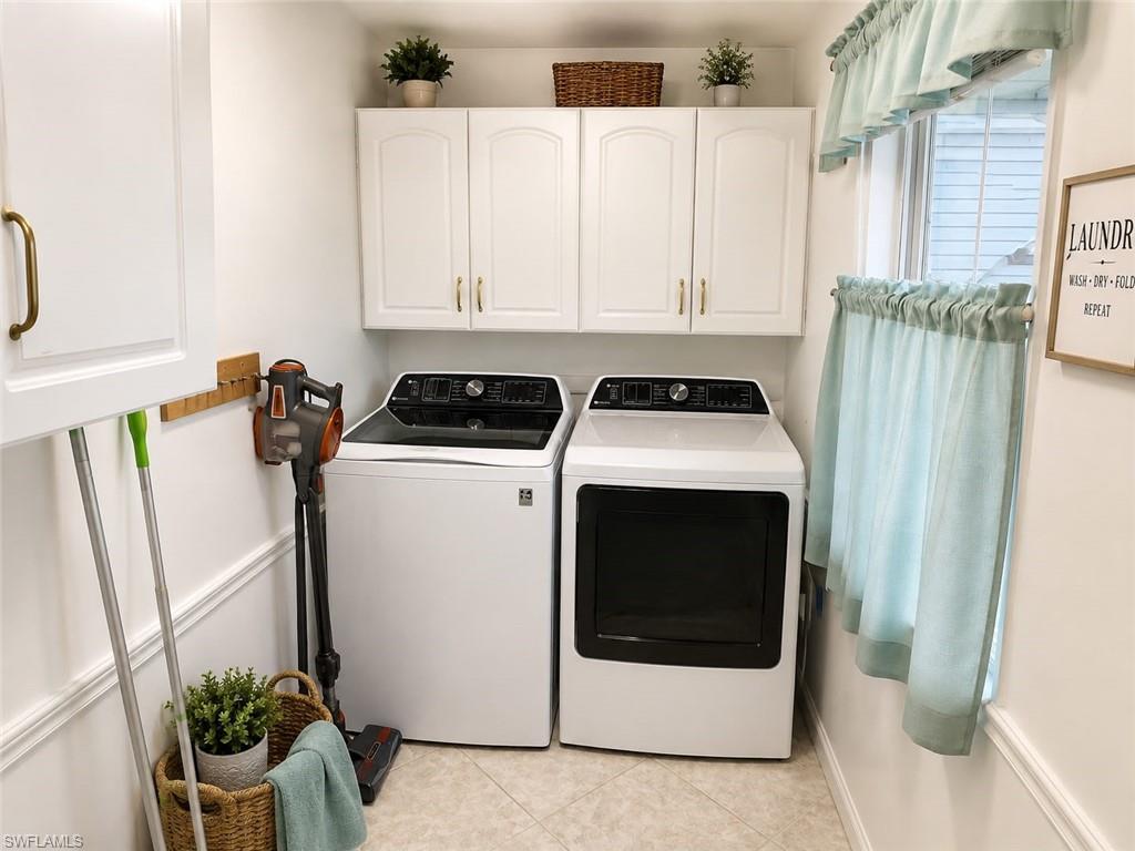 White upper cabinetry with gold-tone hardware