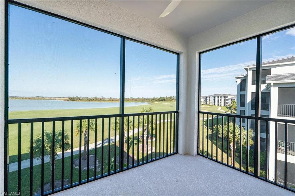 Screened balcony overlooking a lake and golf course