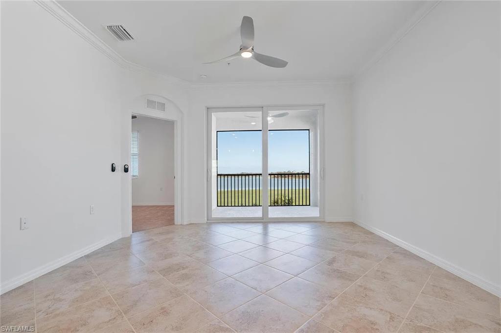 Spacious room with large sliding glass doors opening to a balcony with black railings