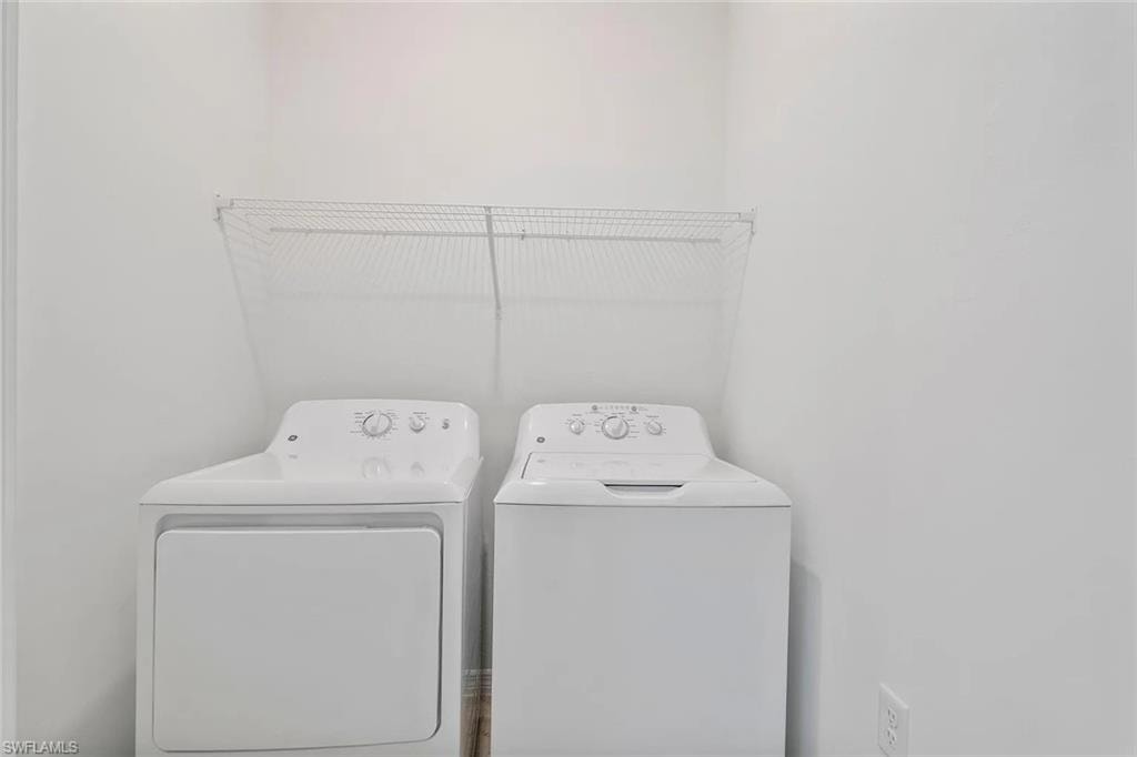 Dedicated laundry area featuring a wire rack shelving unit