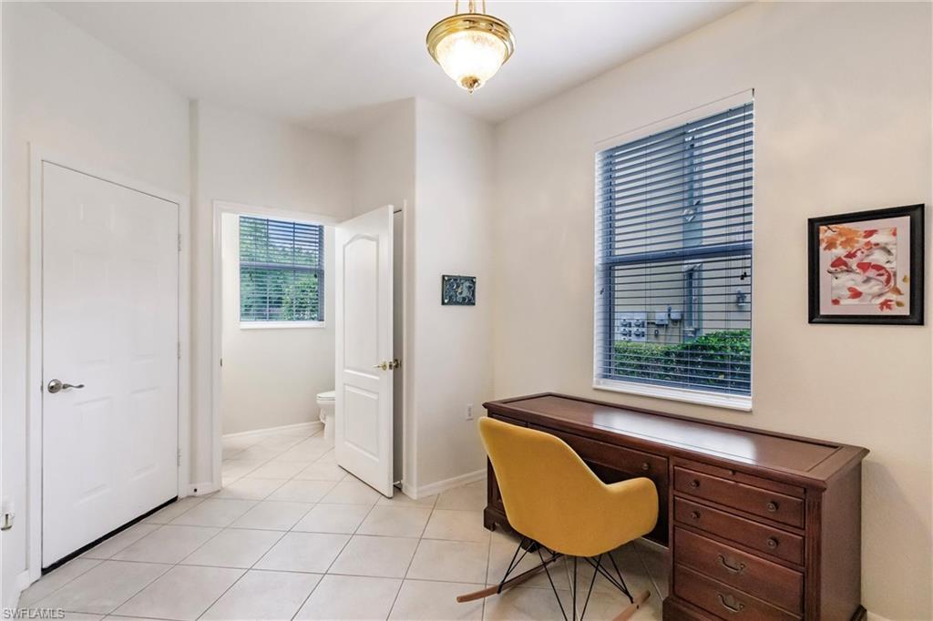 Office space with baseboards and light tile patterned floors