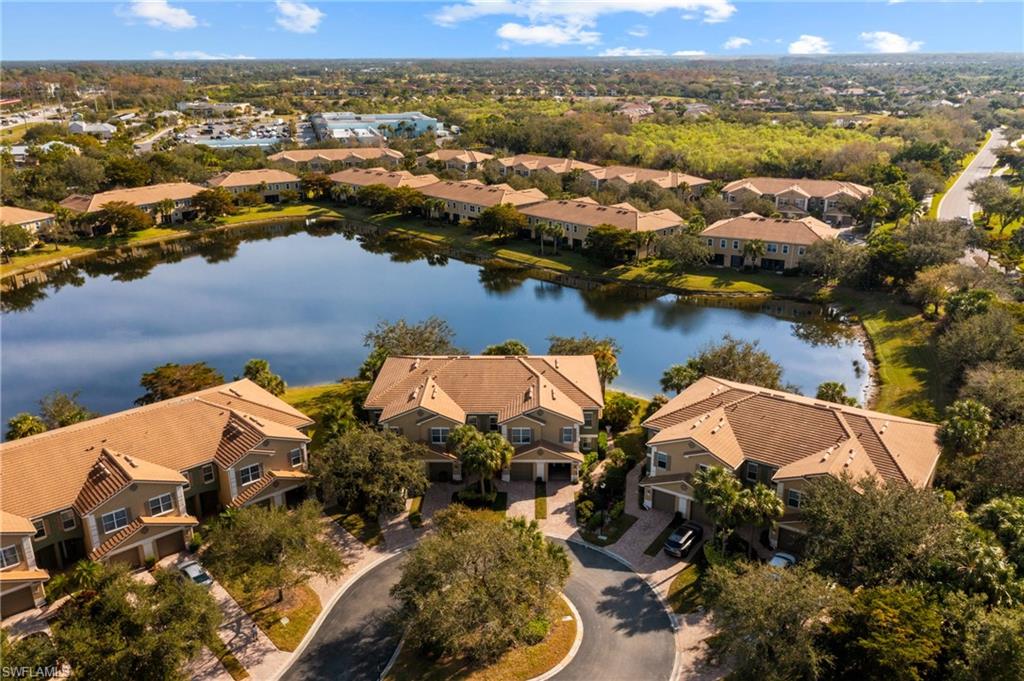 Aerial perspective of suburban area featuring a large body of water