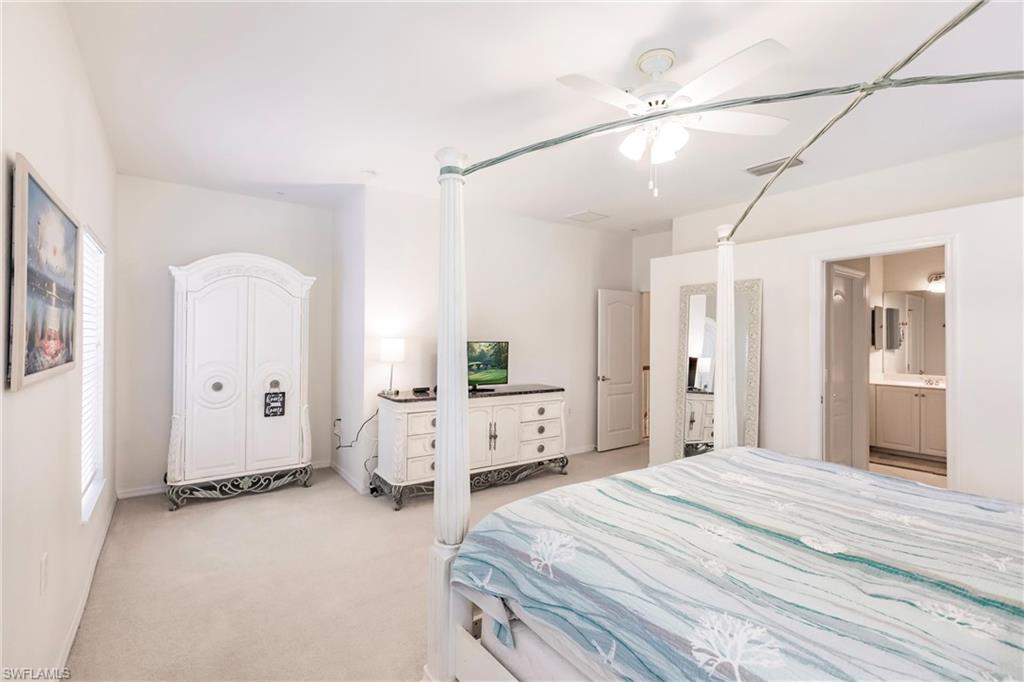 Bedroom featuring light colored carpet and a ceiling fan