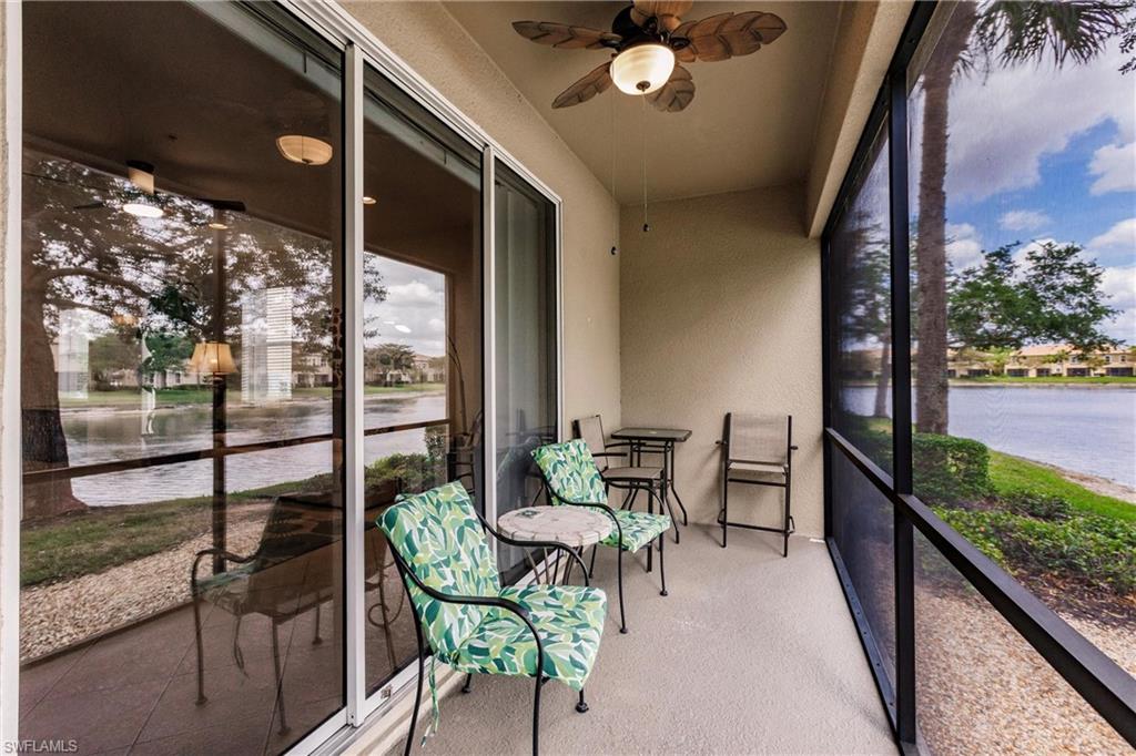 Sunroom with a water view and ceiling fan