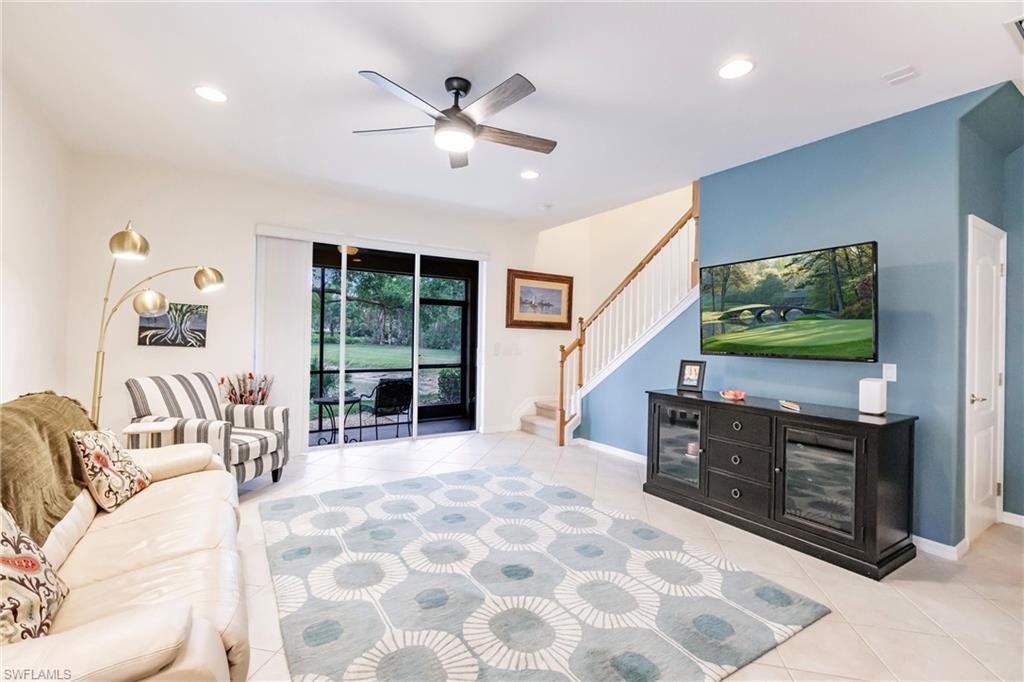 Living area featuring a ceiling fan, light tile patterned floors, and recessed lighting
