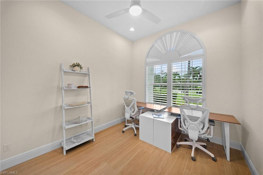 Arched window with plantation shutters and exterior landscaping