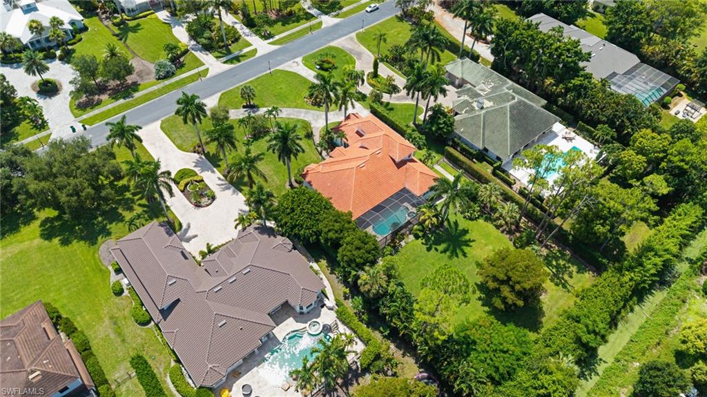Aerial perspective showcasing multiple properties with lush green landscaping