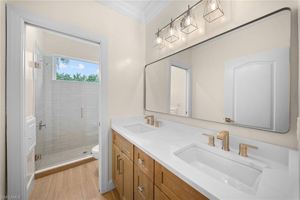 Dual vanity with white countertops and gold-toned fixtures