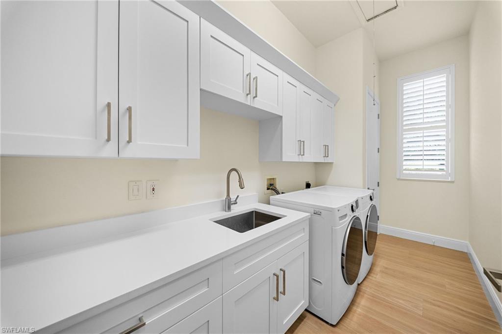 Laundry room with white shaker cabinetry, an undermount sink, and a countertop