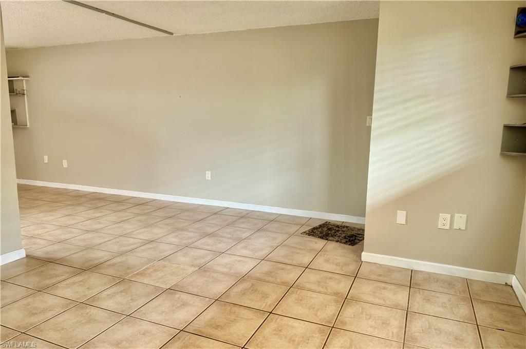 Tile flooring extending throughout the space, complemented by neutral wall tones