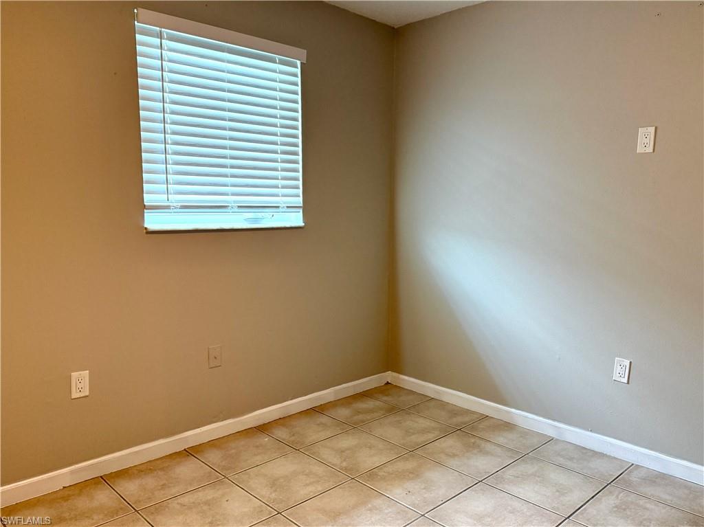 Neutral tone walls with white trim and ceramic tile flooring