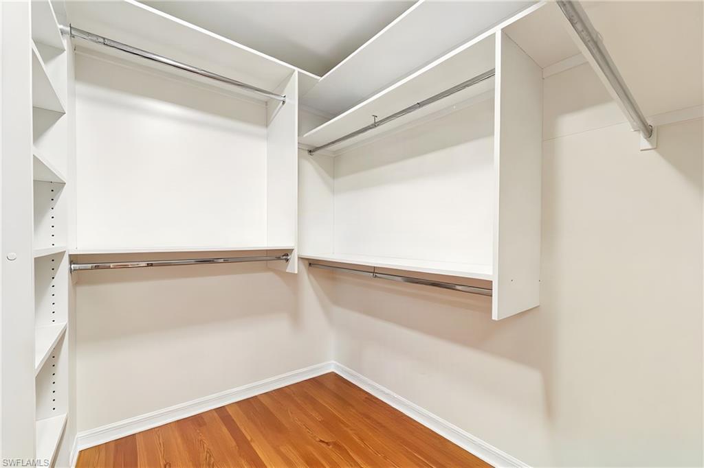 Master bdrm walk in closet with custom fitted California closet systems.