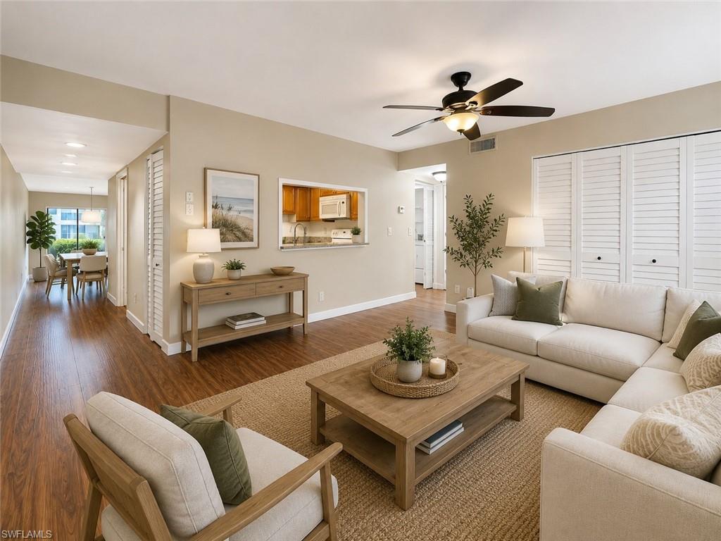 Open-concept living area featuring wood-finish flooring and neutral wall tones